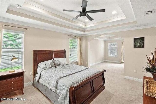 97163 Bluff View Cir, Yulee, FL 32097 - bedroom with a raised ceiling, crown molding, light colored carpet, multiple windows, and recessed lighting
