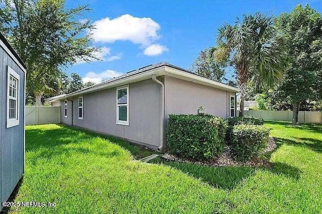 97163 Bluff View Cir, Yulee, FL 32097 - view of property exterior featuring stucco siding and a fenced backyard