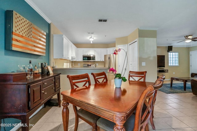 1655 The Greens Way Unit 3416, Jacksonville Beach, FL 32250 - dining area with light tile patterned floors, ceiling fan, and ornamental molding