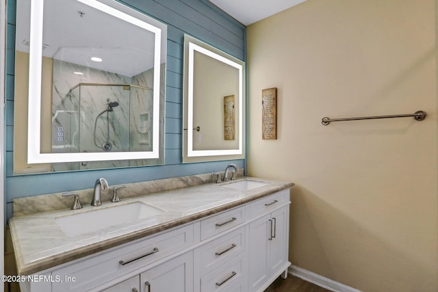 1655 The Greens Way Unit 3416, Jacksonville Beach, FL 32250 - bathroom with a marble finish shower, double vanity, and baseboards