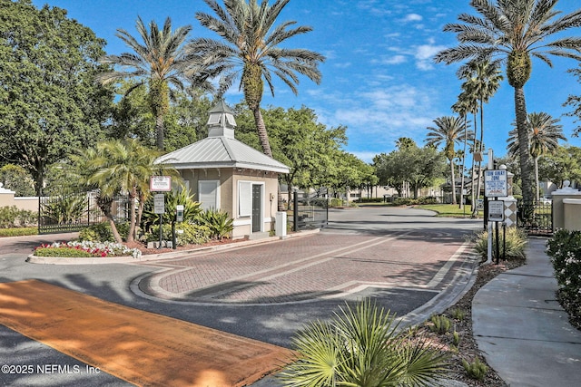 1655 The Greens Way Unit 3416, Jacksonville Beach, FL 32250 - view of decorative street with a gate, a gated entry, and curbs