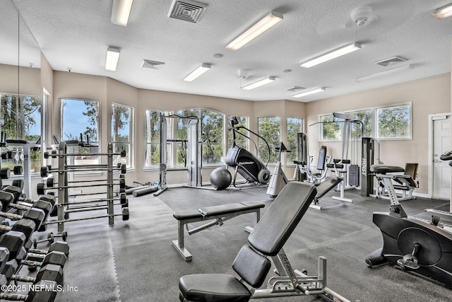 1655 The Greens Way Unit 3416, Jacksonville Beach, FL 32250 - exercise room featuring a textured ceiling and baseboards
