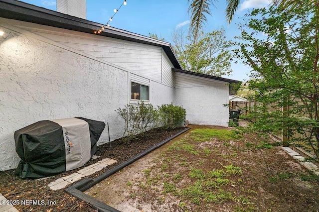 2275 Fairway Villas Ln N, Atlantic Beach, FL 32233 - view of home's exterior with stucco siding and a chimney
