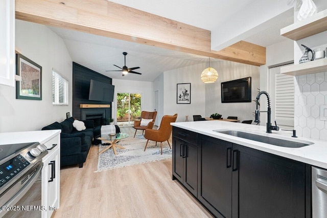 2275 Fairway Villas Ln N, Atlantic Beach, FL 32233 - kitchen featuring a sink, dark cabinetry, open floor plan, and appliances with stainless steel finishes