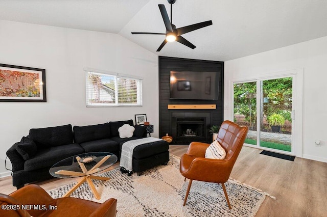 2275 Fairway Villas Ln N, Atlantic Beach, FL 32233 - living area with vaulted ceiling, wood finished floors, a ceiling fan, plenty of natural light, and a fireplace