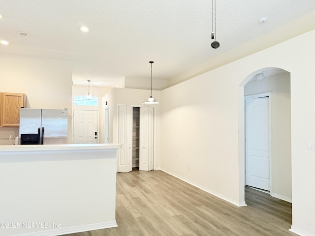 312 Turtle Dove Dr, Orange Park, FL 32073 - unfurnished living room featuring light wood-type flooring, recessed lighting, baseboards, and arched walkways