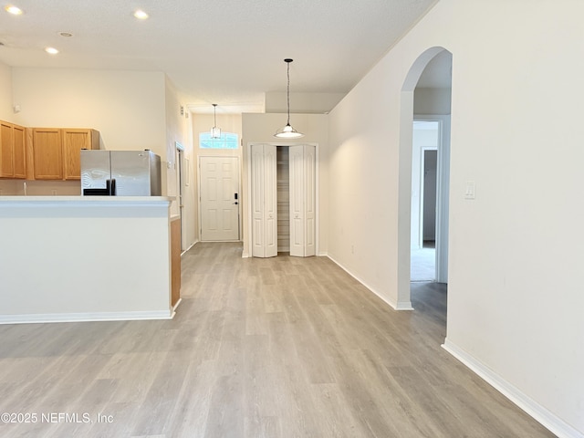 312 Turtle Dove Dr, Orange Park, FL 32073 - kitchen with freestanding refrigerator, arched walkways, light wood-style floors, recessed lighting, and baseboards