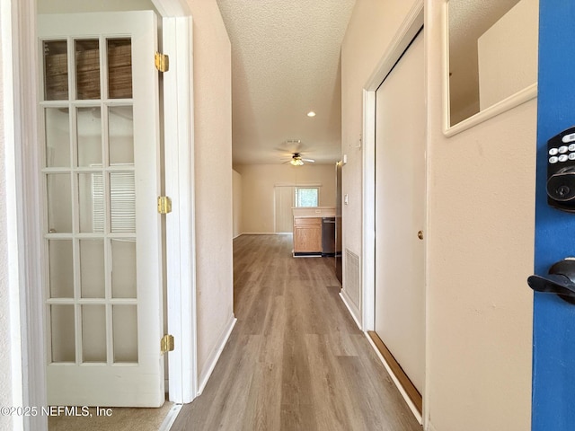 312 Turtle Dove Dr, Orange Park, FL 32073 - corridor with wood finished floors, a textured ceiling, and baseboards