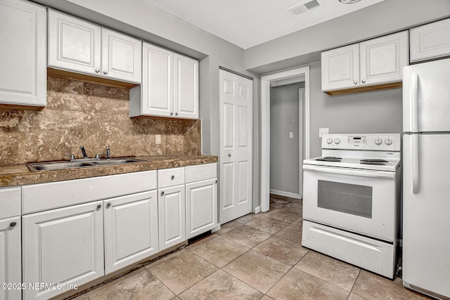 7439 Elvia Dr, Jacksonville, FL 32211 - kitchen featuring white appliances, backsplash, white cabinetry, and a sink