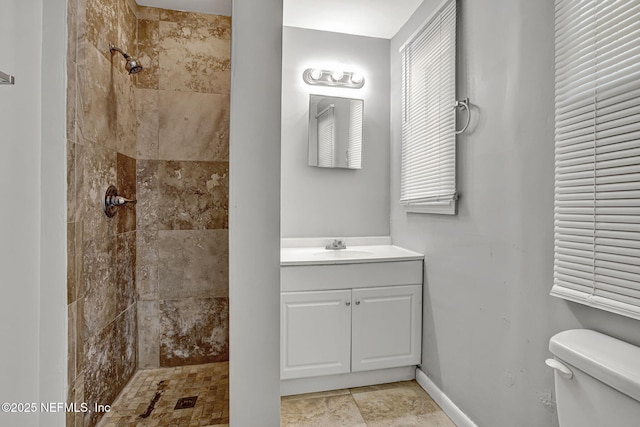 7439 Elvia Dr, Jacksonville, FL 32211 - full bath featuring a tile shower, vanity, toilet, and baseboards