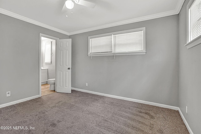 7439 Elvia Dr, Jacksonville, FL 32211 - unfurnished bedroom featuring carpet floors, ornamental molding, baseboards, ensuite bath, and a ceiling fan
