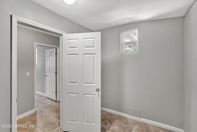 7439 Elvia Dr, Jacksonville, FL 32211 - hall featuring baseboards, light tile patterned floors, and lofted ceiling