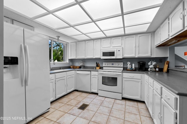 2279 Seminole Rd Unit 11, Atlantic Beach, FL 32233 - kitchen with white appliances, white cabinets, light tile patterned floors, and a sink