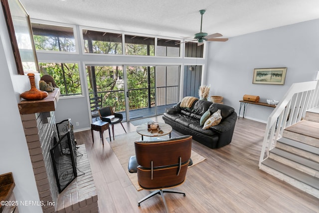 2279 Seminole Rd Unit 11, Atlantic Beach, FL 32233 - living room featuring healthy amount of natural light, stairway, ceiling fan, wood finished floors, and a textured ceiling