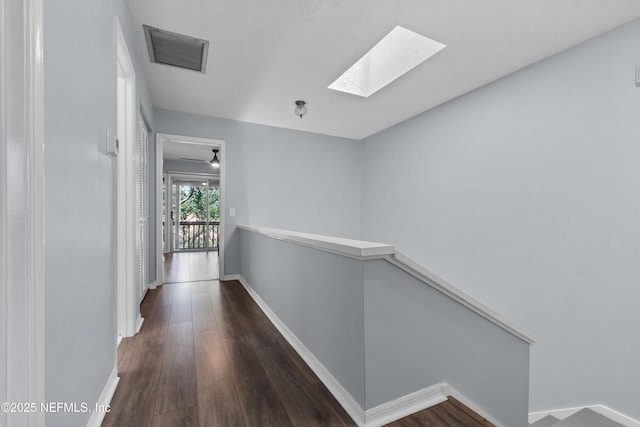 2279 Seminole Rd Unit 11, Atlantic Beach, FL 32233 - hallway with a skylight, wood finished floors, baseboards, and an upstairs landing