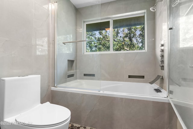 2279 Seminole Rd Unit 11, Atlantic Beach, FL 32233 - bathroom featuring toilet, plenty of natural light, tiled shower / bath combo, and tile walls
