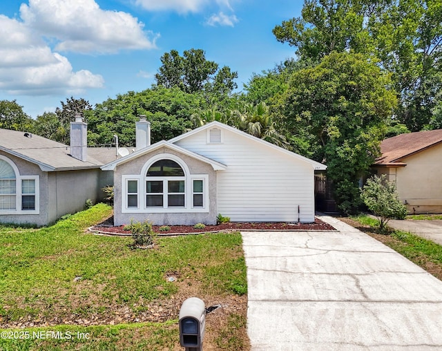257 Jasmine St, Atlantic Beach, FL 32233 - view of front of home with a front lawn and concrete driveway