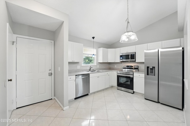 257 Jasmine St, Atlantic Beach, FL 32233 - kitchen featuring stainless steel appliances, a sink, light countertops, lofted ceiling, and white cabinets