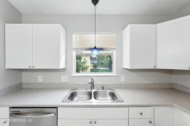 257 Jasmine St, Atlantic Beach, FL 32233 - kitchen with dishwasher, a sink, white cabinetry, light countertops, and a textured ceiling