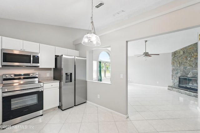 257 Jasmine St, Atlantic Beach, FL 32233 - kitchen with appliances with stainless steel finishes, white cabinetry, baseboards, and light tile patterned floors