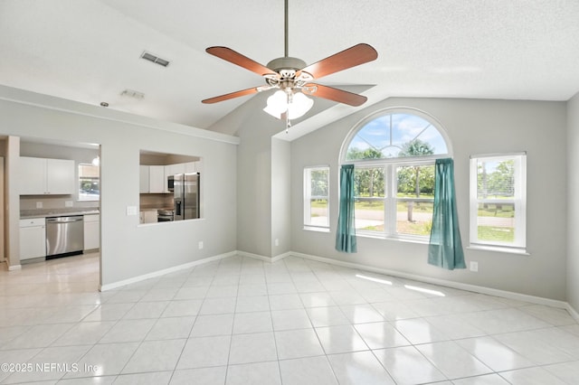 257 Jasmine St, Atlantic Beach, FL 32233 - spare room featuring lofted ceiling, a ceiling fan, plenty of natural light, baseboards, and light tile patterned floors