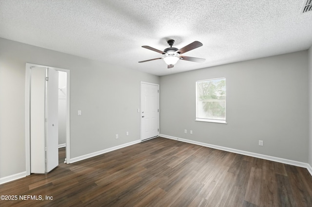 257 Jasmine St, Atlantic Beach, FL 32233 - unfurnished bedroom featuring dark wood-type flooring, baseboards, a textured ceiling, and ceiling fan