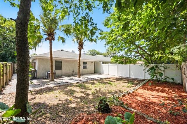 257 Jasmine St, Atlantic Beach, FL 32233 - rear view of house with a patio area, a fenced backyard, and central AC unit