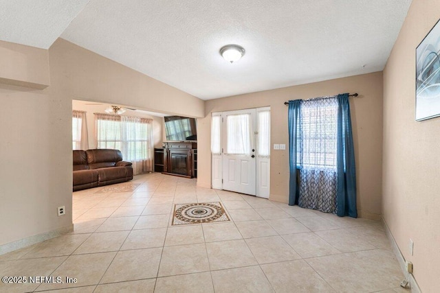 17 Rollins Ave, Saint Augustine, FL 32084 - entryway featuring healthy amount of natural light, light tile patterned floors, a textured ceiling, baseboards, and a ceiling fan