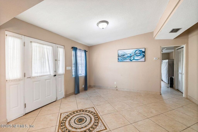 17 Rollins Ave, Saint Augustine, FL 32084 - foyer entrance featuring light tile patterned flooring, baseboards, and a textured ceiling