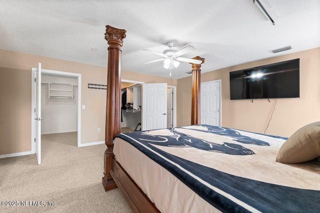 17 Rollins Ave, Saint Augustine, FL 32084 - carpeted bedroom with baseboards, a textured ceiling, a spacious closet, and a ceiling fan