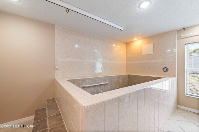 17 Rollins Ave, Saint Augustine, FL 32084 - bathroom featuring tile patterned flooring, a textured ceiling, baseboards, tiled shower, and recessed lighting
