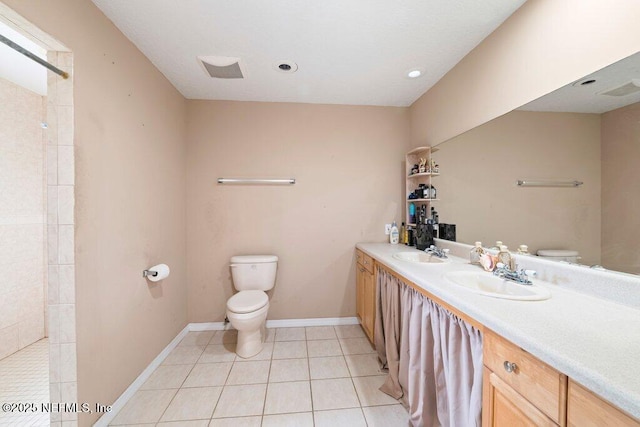 17 Rollins Ave, Saint Augustine, FL 32084 - full bathroom with toilet, double vanity, tiled shower, tile patterned floors, and baseboards