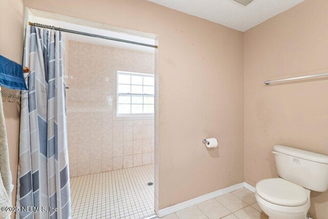 17 Rollins Ave, Saint Augustine, FL 32084 - bathroom featuring a shower stall, toilet, tile patterned floors, and baseboards
