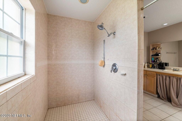 17 Rollins Ave, Saint Augustine, FL 32084 - bathroom featuring a tile shower, tile patterned floors, and vanity