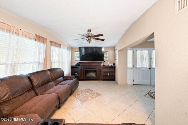 17 Rollins Ave, Saint Augustine, FL 32084 - living room with light tile patterned floors, ceiling fan, a glass covered fireplace, and vaulted ceiling