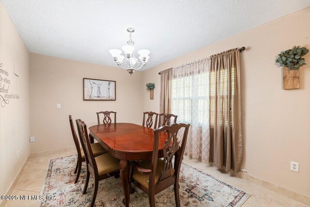 17 Rollins Ave, Saint Augustine, FL 32084 - dining space with a chandelier and light tile patterned flooring