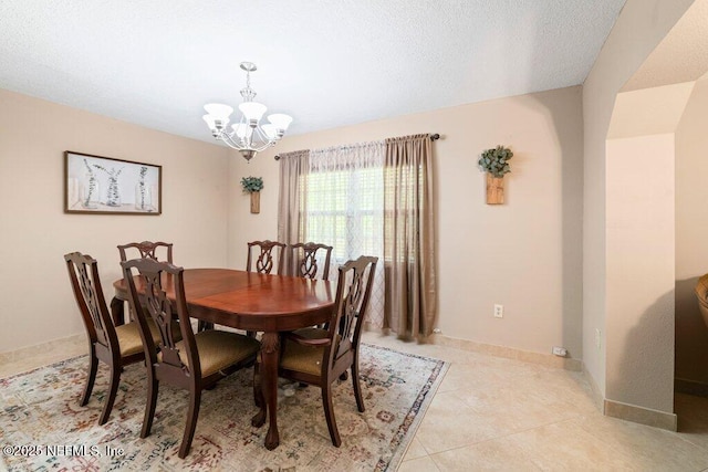 17 Rollins Ave, Saint Augustine, FL 32084 - dining area featuring a chandelier, light tile patterned flooring, and baseboards