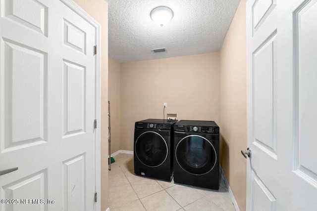 17 Rollins Ave, Saint Augustine, FL 32084 - laundry area with separate washer and dryer, baseboards, light tile patterned floors, and a textured ceiling