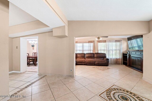 17 Rollins Ave, Saint Augustine, FL 32084 - living room featuring light tile patterned flooring, a chandelier, baseboards, and a ceiling fan