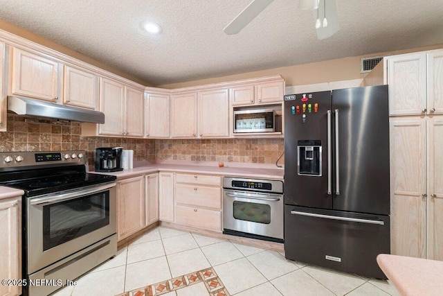 17 Rollins Ave, Saint Augustine, FL 32084 - kitchen with appliances with stainless steel finishes, under cabinet range hood, light countertops, tasteful backsplash, and a textured ceiling