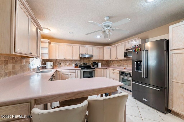 17 Rollins Ave, Saint Augustine, FL 32084 - kitchen featuring stainless steel appliances, under cabinet range hood, open shelves, a peninsula, and a ceiling fan