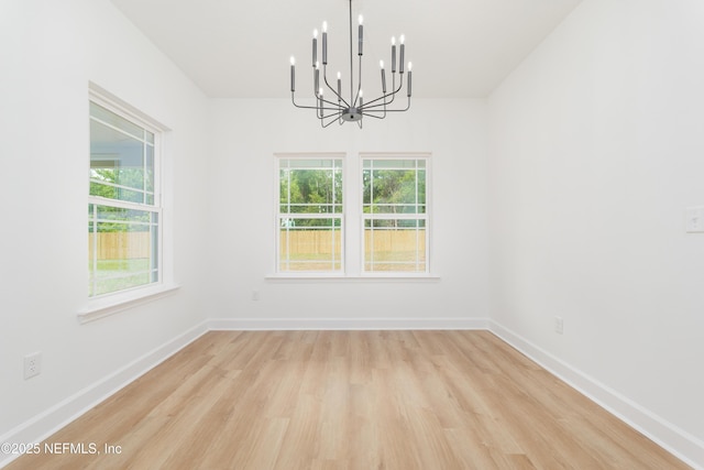 1873 Openwoods Rd, Middleburg, FL 32068 - spare room with a chandelier, light wood-style flooring, and baseboards