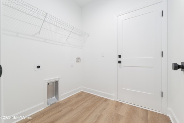 1873 Openwoods Rd, Middleburg, FL 32068 - laundry room with hookup for an electric dryer, light wood finished floors, and baseboards