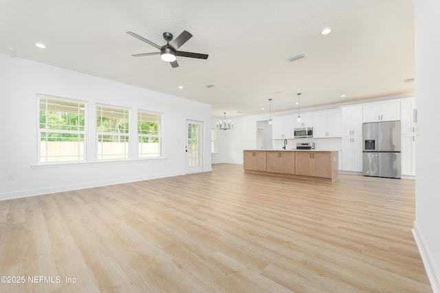 1873 Openwoods Rd, Middleburg, FL 32068 - unfurnished living room with a chandelier, a ceiling fan, light wood-type flooring, recessed lighting, and baseboards