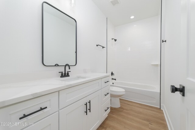1873 Openwoods Rd, Middleburg, FL 32068 - full bath with toilet, vanity, wood finished floors, and washtub / shower combination
