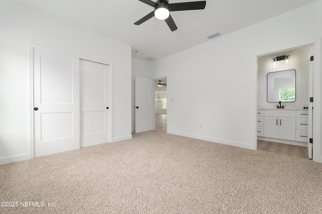 1873 Openwoods Rd, Middleburg, FL 32068 - unfurnished bedroom with light colored carpet, a closet, ensuite bath, and baseboards