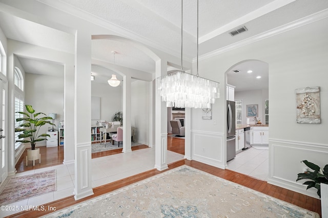 784 Mill Stream Rd, Ponte Vedra Beach, FL 32082 - dining area with light wood-style floors, arched walkways, crown molding, and a chandelier