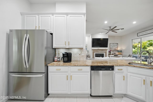 784 Mill Stream Rd, Ponte Vedra Beach, FL 32082 - kitchen with stainless steel appliances, a sink, a ceiling fan, tasteful backsplash, and white cabinetry