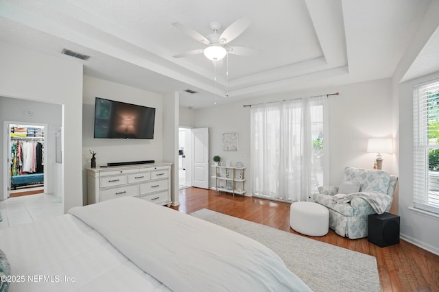 784 Mill Stream Rd, Ponte Vedra Beach, FL 32082 - bedroom featuring a raised ceiling, a walk in closet, wood finished floors, ceiling fan, and a closet