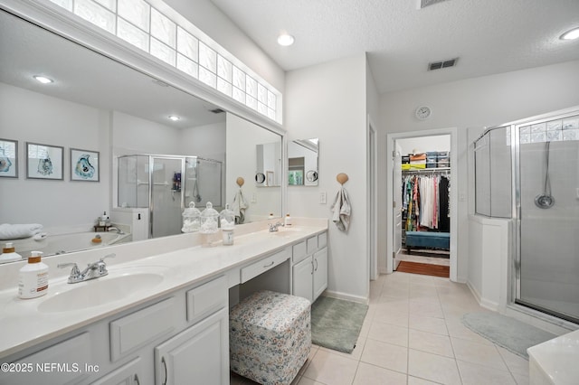 784 Mill Stream Rd, Ponte Vedra Beach, FL 32082 - full bath with double vanity, a shower stall, a walk in closet, tile patterned flooring, and a garden tub